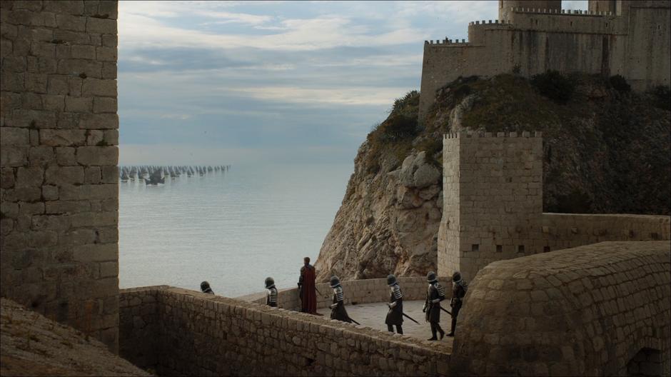 Jaime looks out at the fleet while Cersei's guards follow her out.