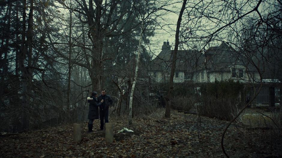 Virginia Coady attempts to comfort Mark Rollins as he looks down at Ira's grave.