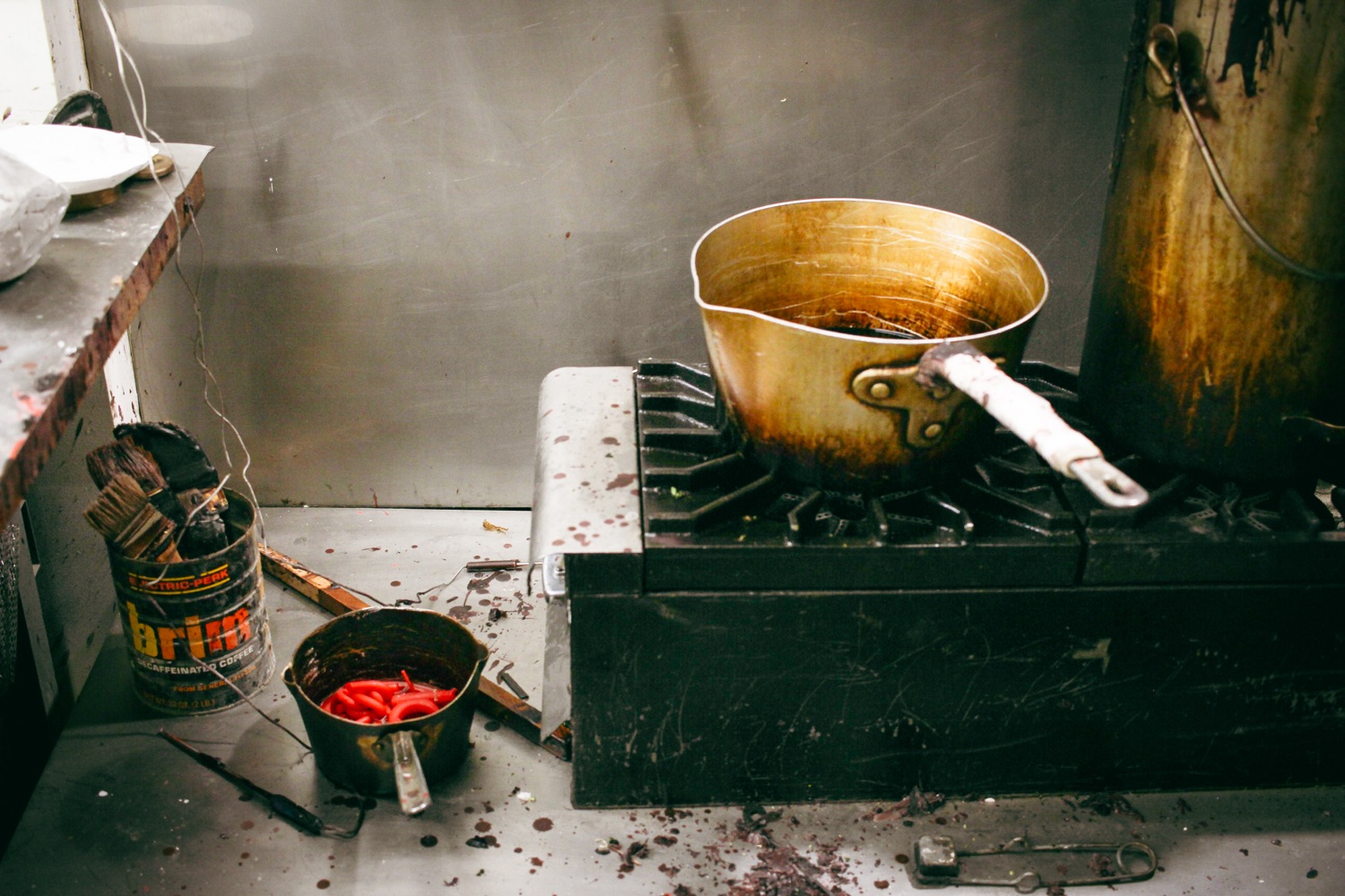 Dirty pot on a black stovetop.