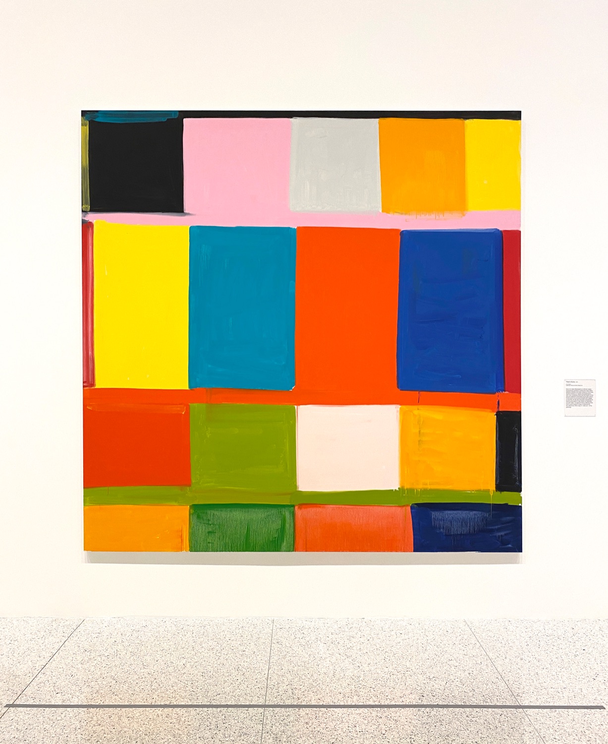Large abstract painting of a colorful grid