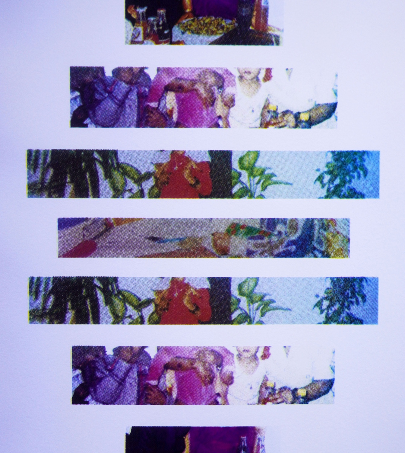 Horizontal bands of colorful cropped photography printed on white paper