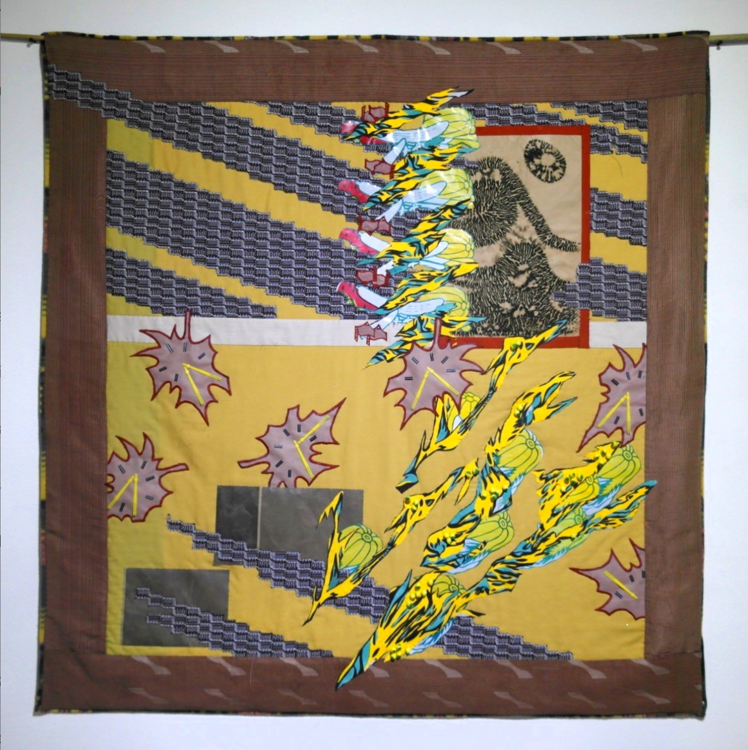 Abstract quilt in yellow, brown, and printed fabrics