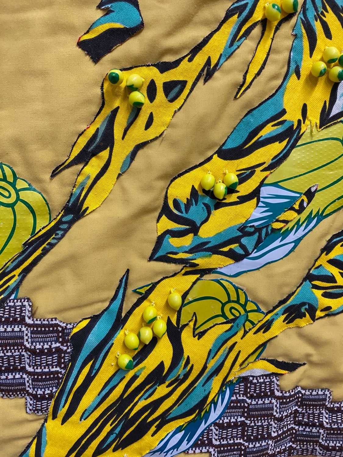 Detail of quilt with yellow lemon beads
