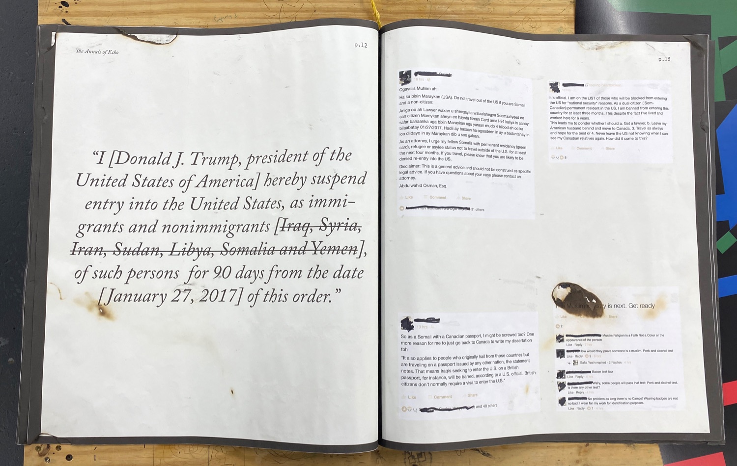 Oversized open book of printed out tweets and facebook posts, pages torn and burnt