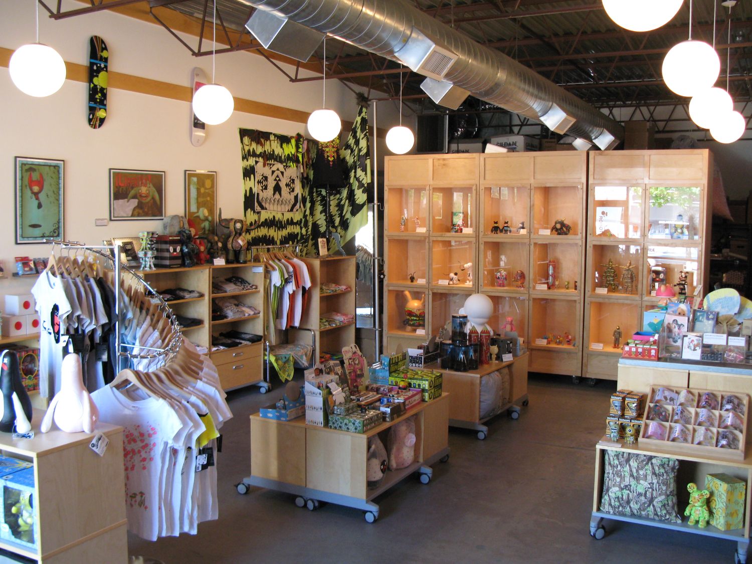 Inside of a store selling skate decks, shirts, and figurines