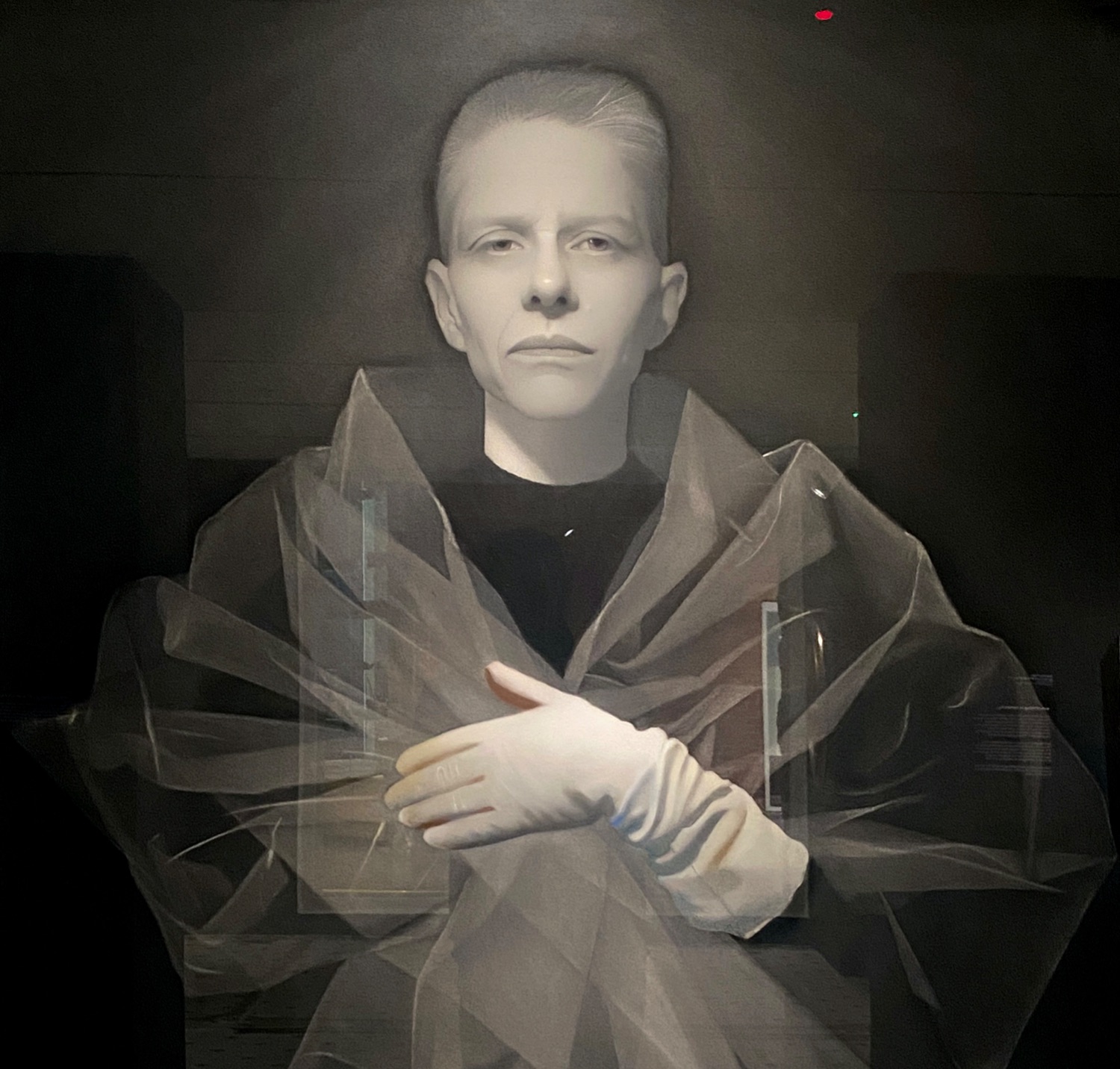 Charcoal drawing of woman with flattop haircut and shrouded in thin fabric