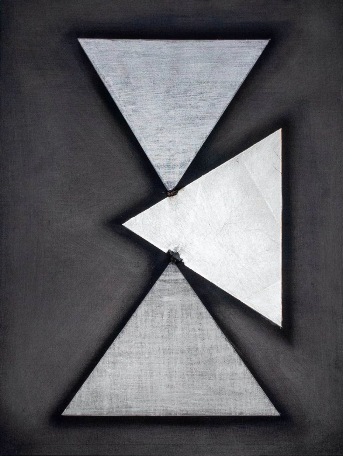 Geometric drawing of three gray triangles intersecting on a black background
