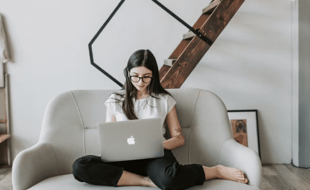 A woman in front of her computer