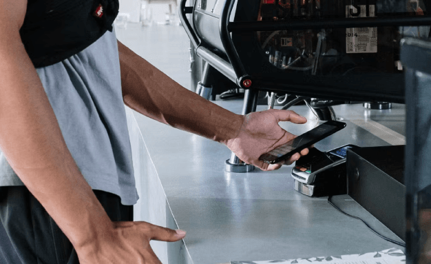 A man makes a contactless payment with his smartphone