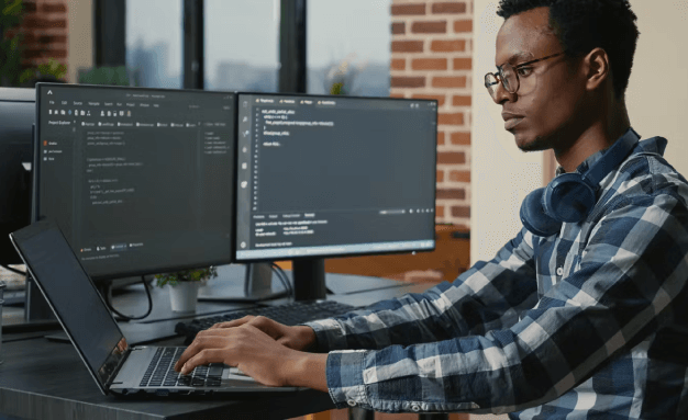 A man coding a program on his computer