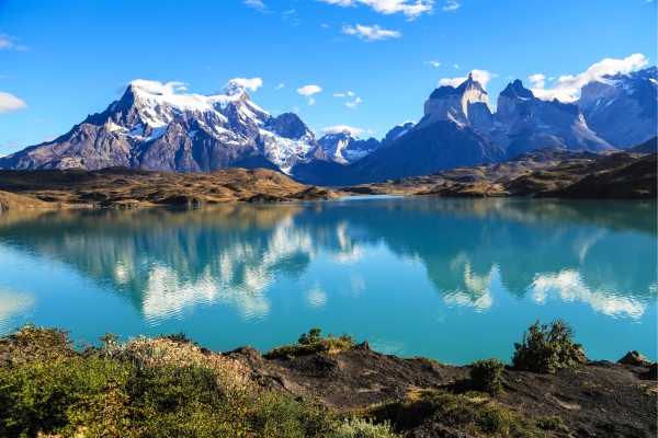 Snow-Capped Peaks In Patagonia With A Lake In The Foreground Snow-Capped Peaks In Patagonia With A Lake In The Foreground