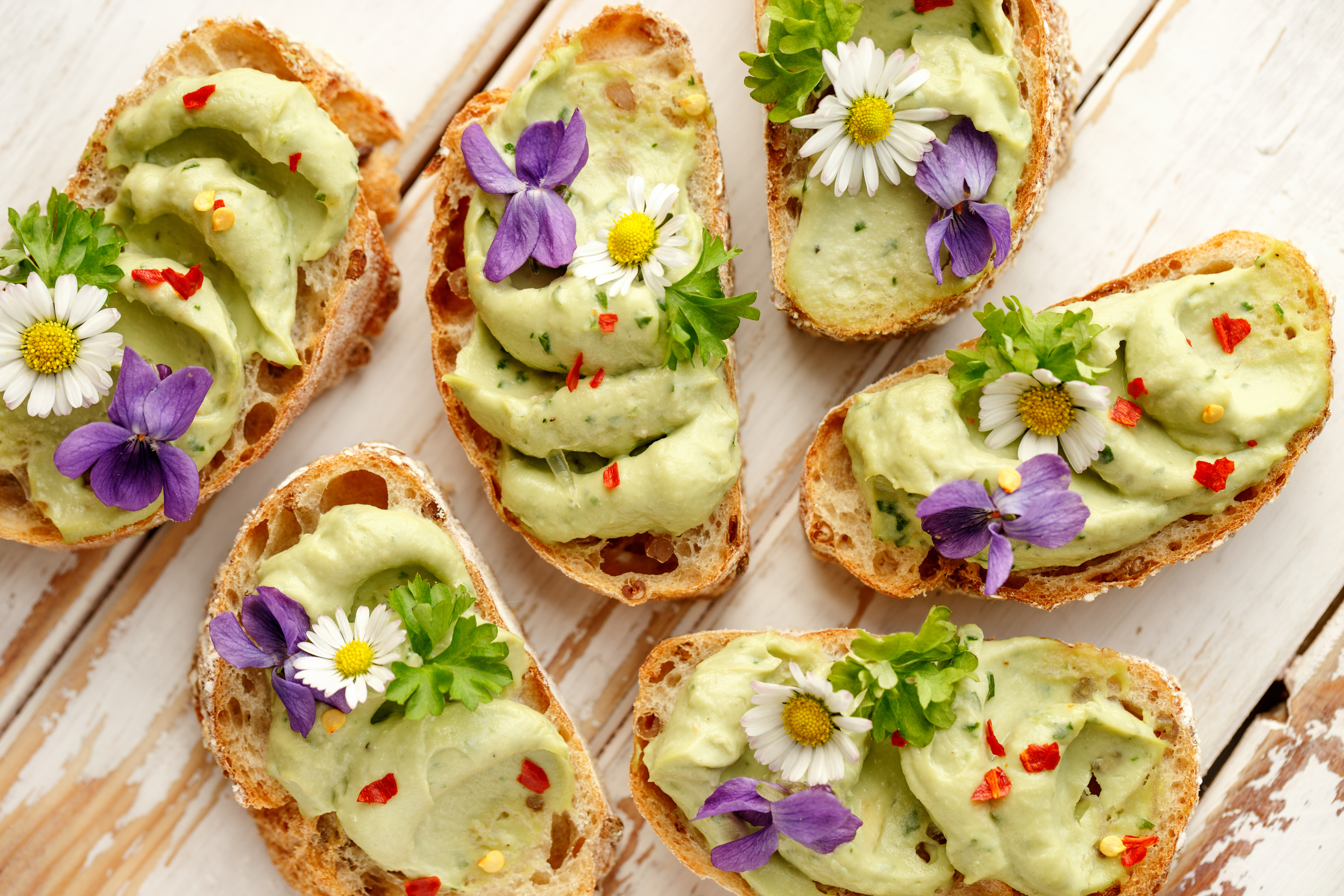 Top off artisan toast with edible flowers.
