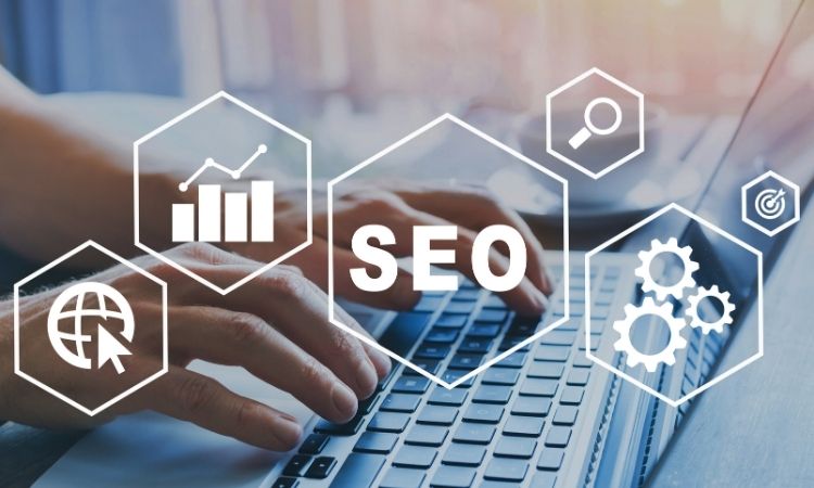 Hands typing on laptop keyboard with SEO icons overlay showing analytics, search, global web, and optimization symbols. Hands typing on laptop keyboard with SEO icons overlay showing analytics, search, global web, and optimization symbols.