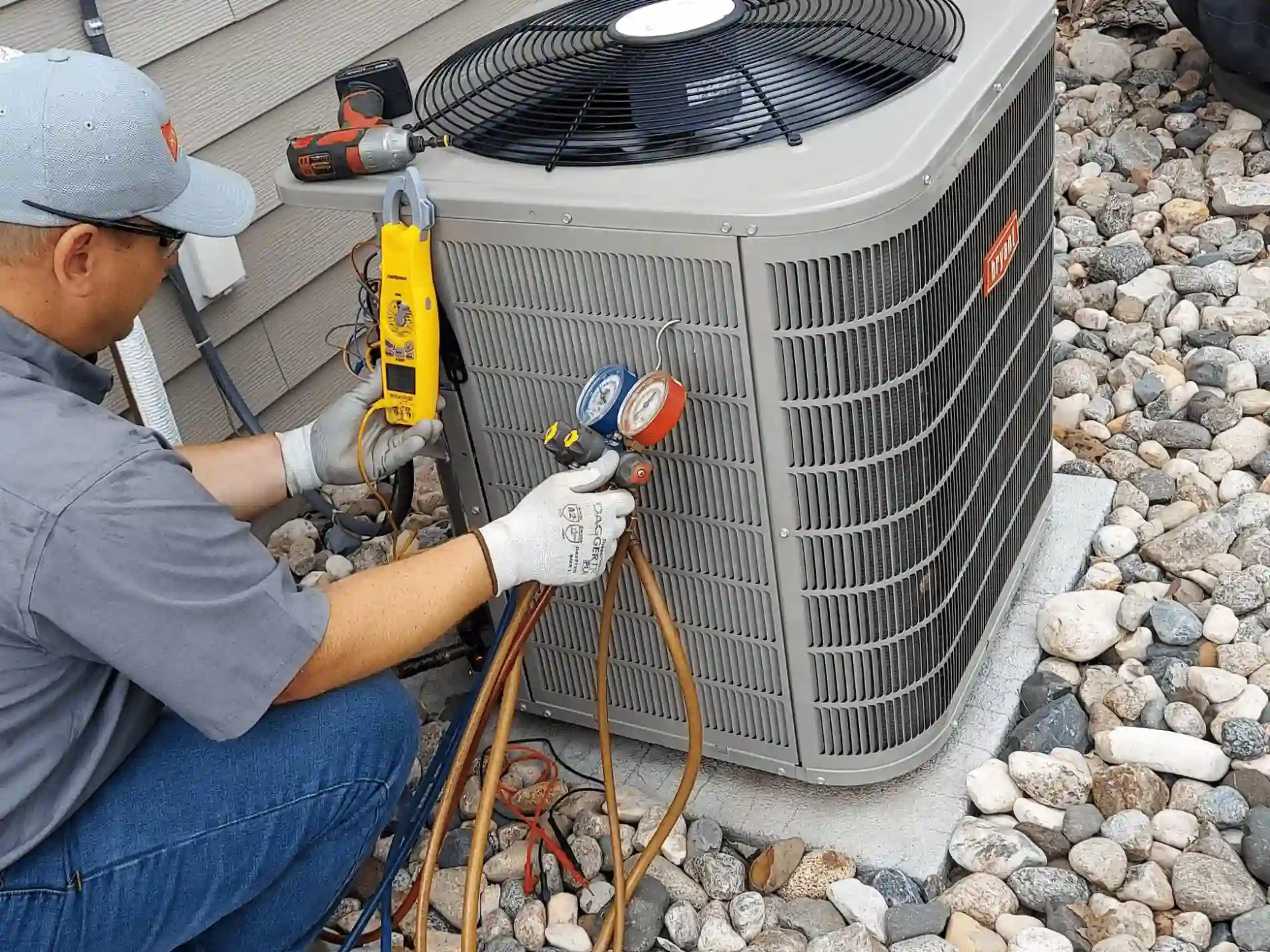 a technician holding some tools to check on the AC unit.
