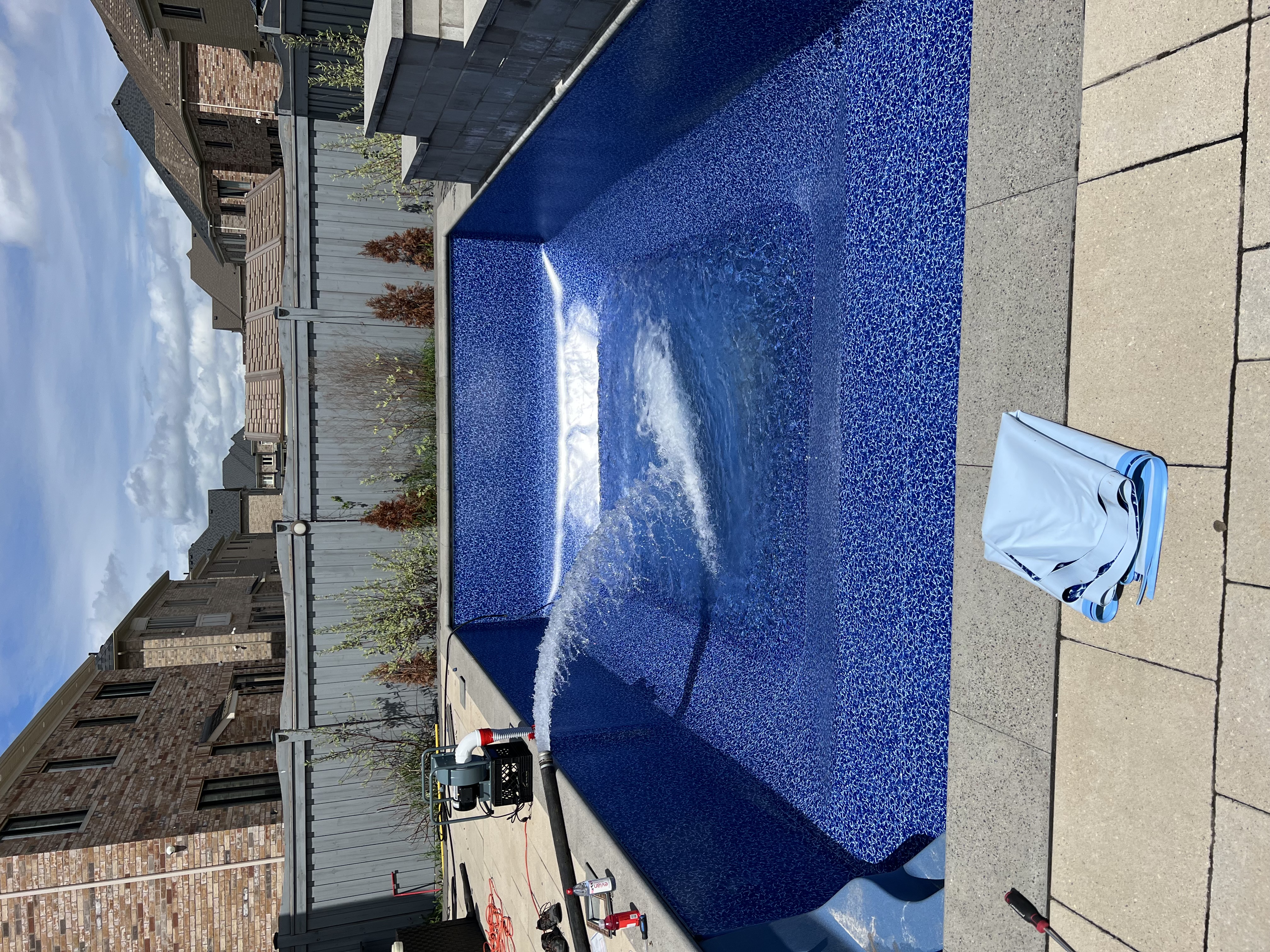 Professional weekly pool maintenance service being performed at a residential pool in Ontario