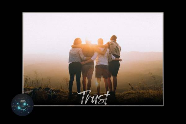 Group of people embracing at sunset, symbolizing the trust and strong relationships that are vital for small business reputation management.