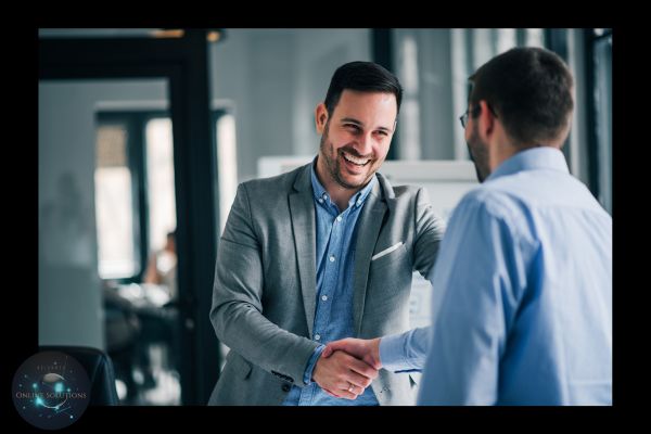 A business professional smiling and shaking hands, symbolizing the blog's focus on building genuine client relationships. This reflects the rejection of cold calling in favor of creating meaningful, trust-based connections through a consultative approach.