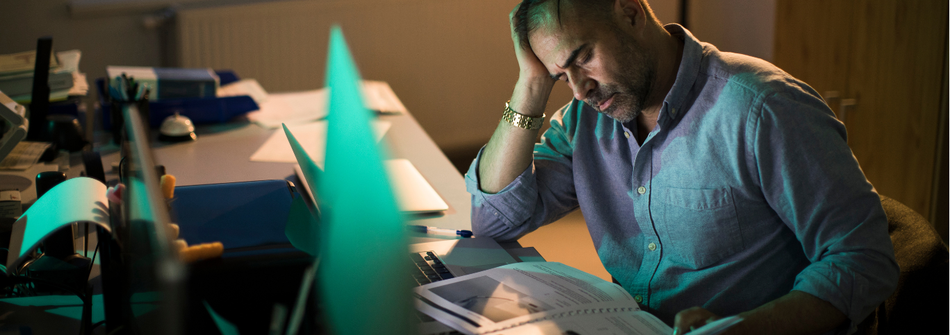 a man sitting in front of a laptop computer.