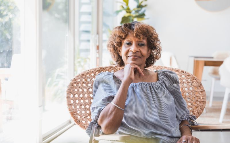 Elderly woman sitting in the living room of her ADU.