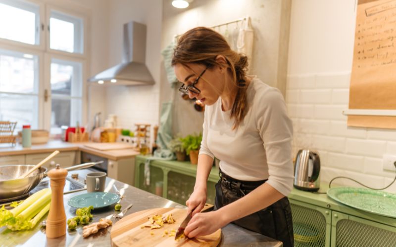 Woman meal prepping vegetables.