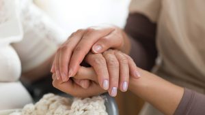 holding elderly's hands