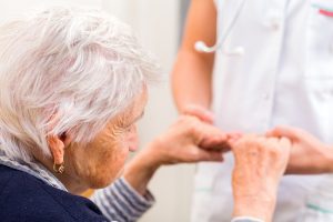 nurse holding an old lady