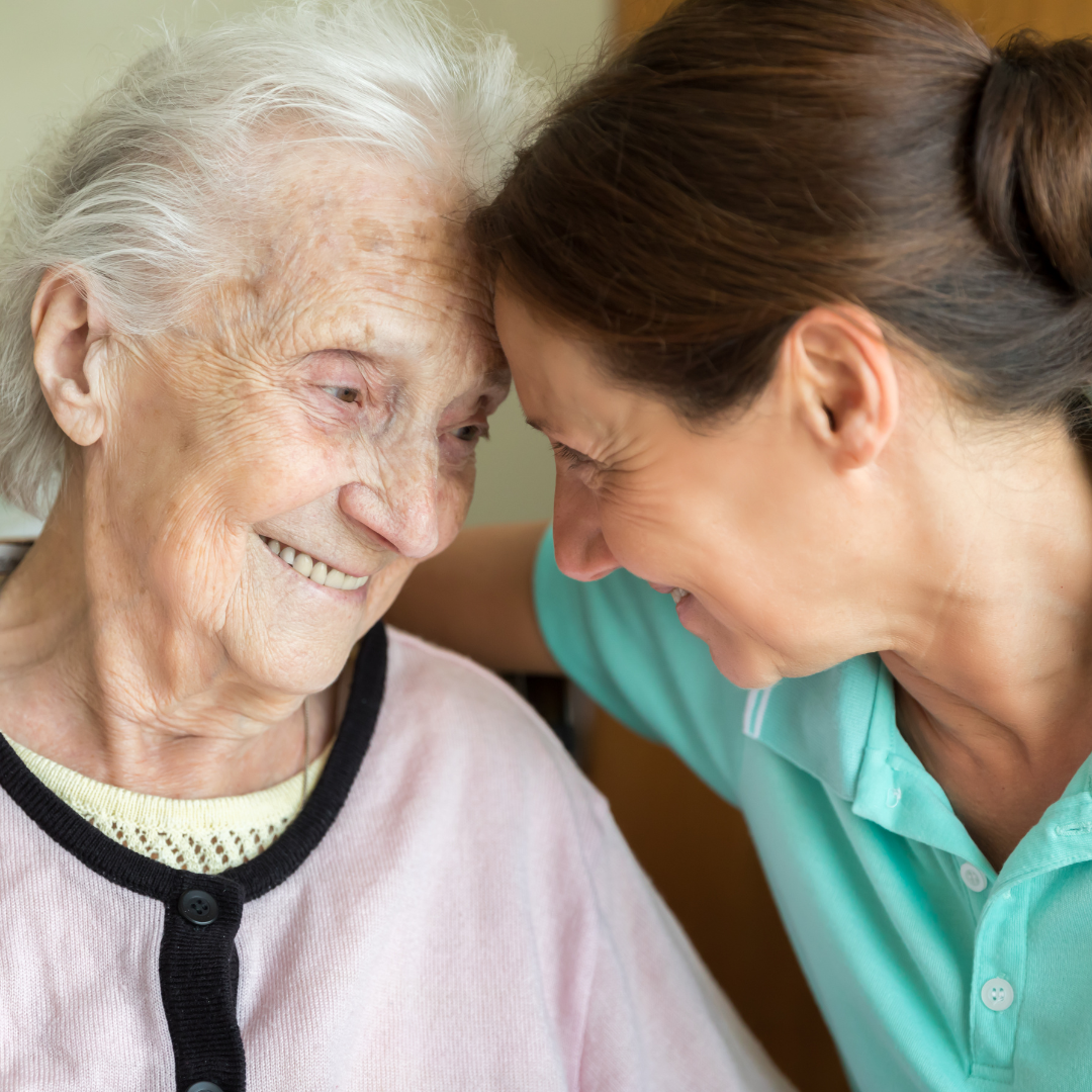 caregiver hugging an elderly patient