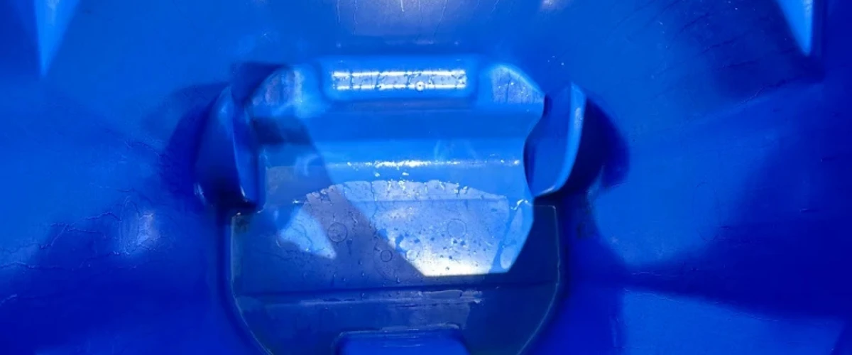 Clean and shiny blue trash bin interior after professional cleaning.