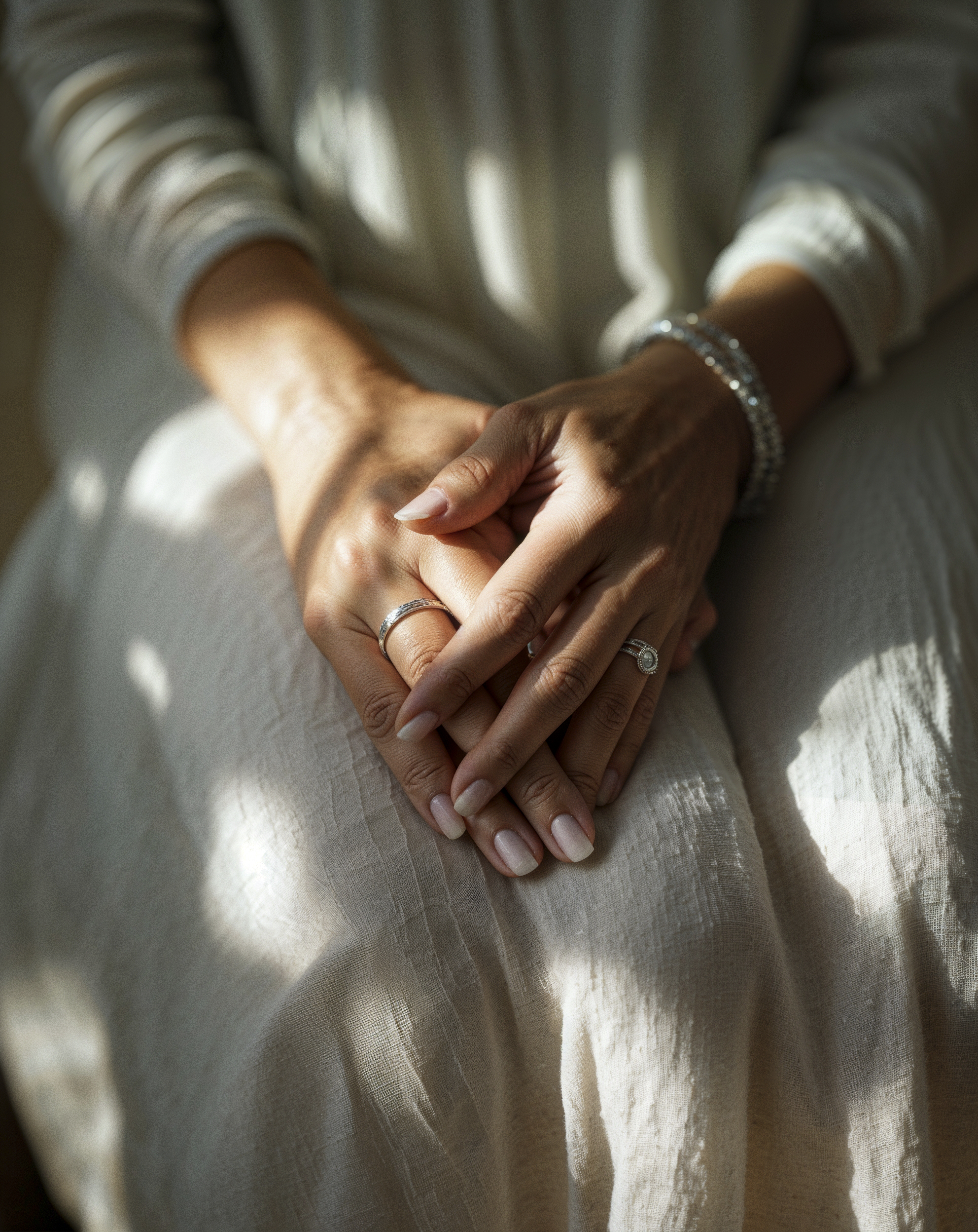 Close-up of a woman’s hands over her heart in morning light, honouring self-connection and care. Close-up of a woman’s hands over her heart in morning light, honouring self-connection and care.