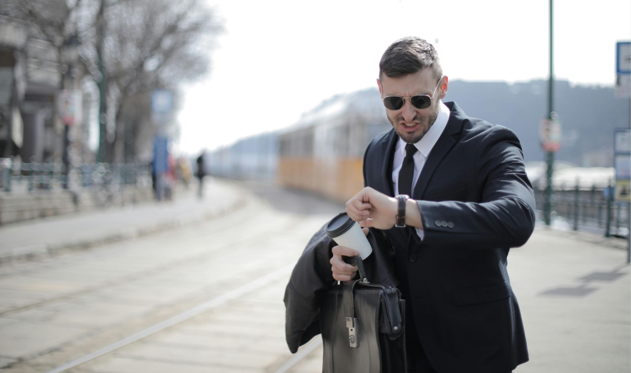 A business man noticing the time and realising he is late, one of many pain points of online business A business man noticing the time and realising he is late, one of many pain points of online business