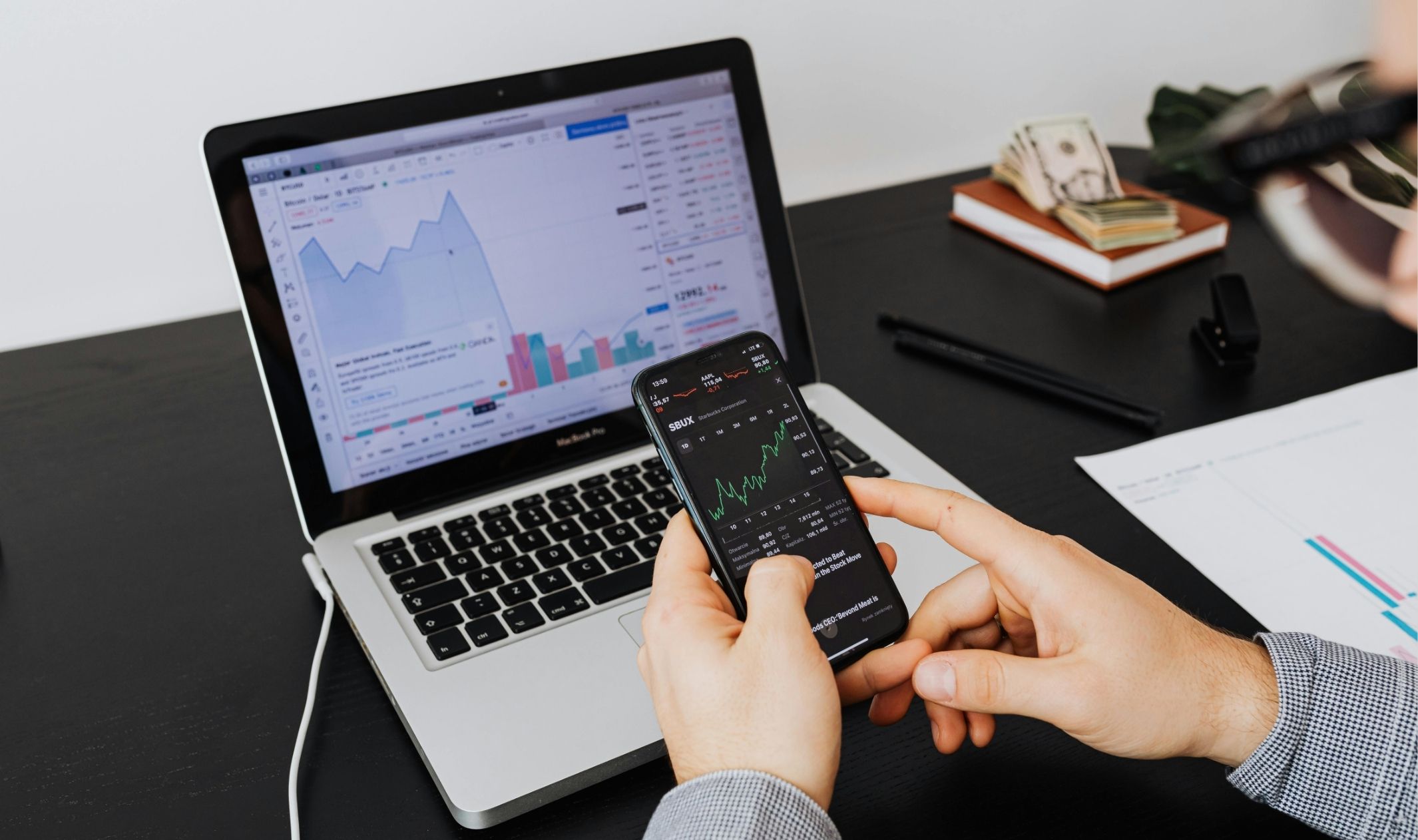 Graphs on a laptop and a phone showing increased profits after using sales funnels that convert