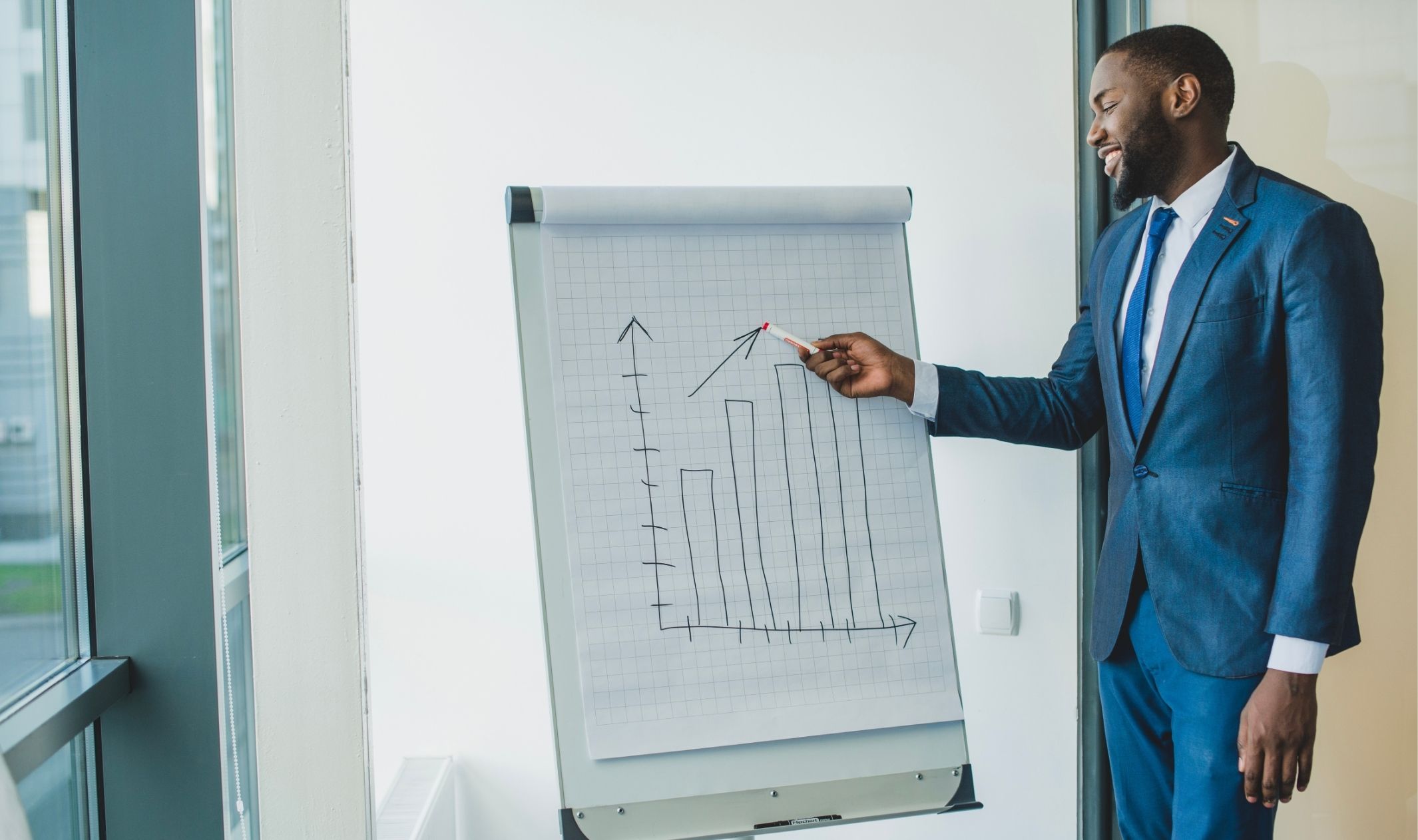 A business man showing realistic entrepreneur expectations on a chart A business man showing realistic entrepreneur expectations on a chart