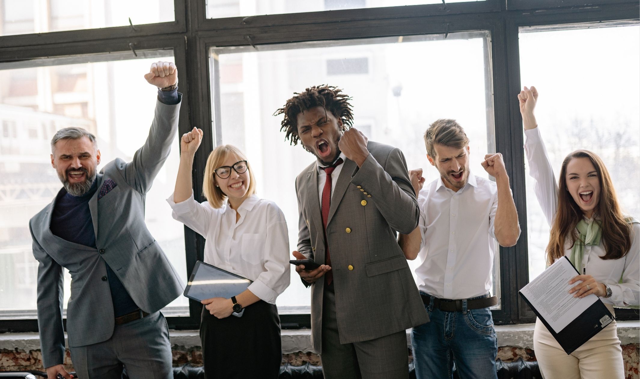 A group of employees celebrating after building an online business from scratch A group of employees celebrating after building an online business from scratch