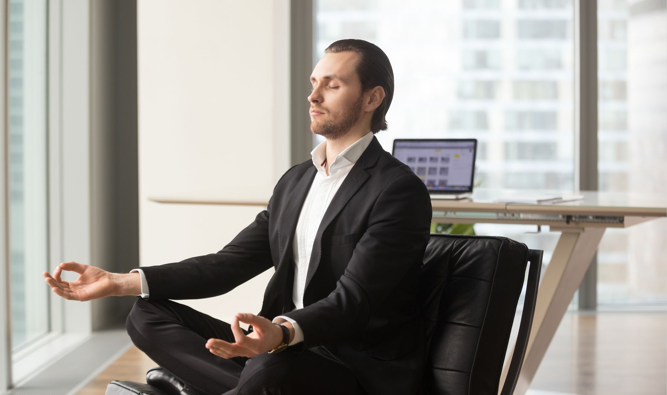 A business man meditating at his desk to maintain the entrepreneurship work-life balance A business man meditating at his desk to maintain the entrepreneurship work-life balance
