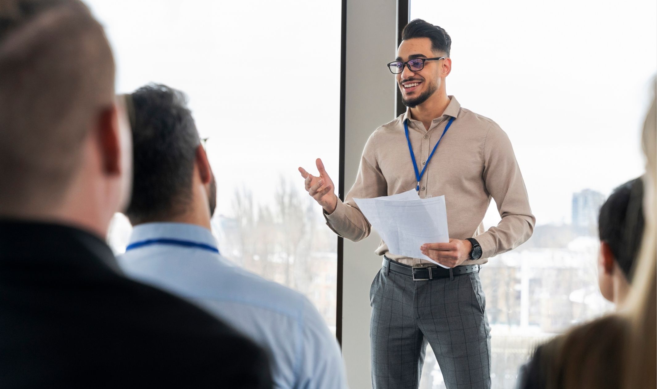 A business owner giving a speech and building an audience because he understands the importance of marketing in entrepreneurship A business owner giving a speech and building an audience because he understands the importance of marketing in entrepreneurship
