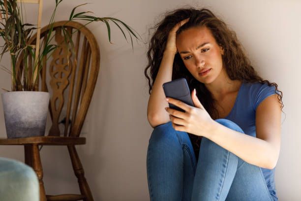 Woman accessing relationship coaching services via smartphone at Live Beyond Doubt