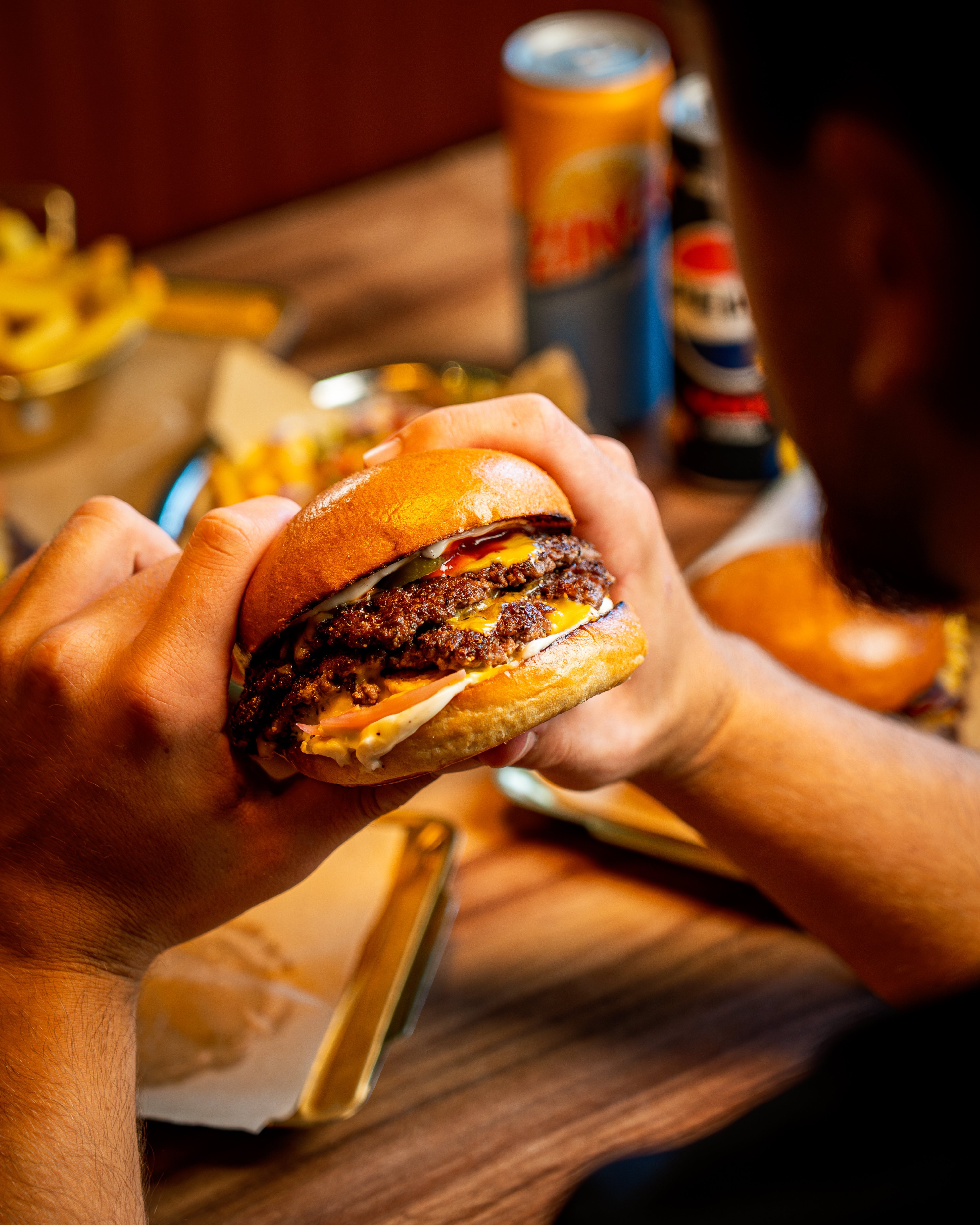 Chef seasoning a premium cut of beef on a wooden board