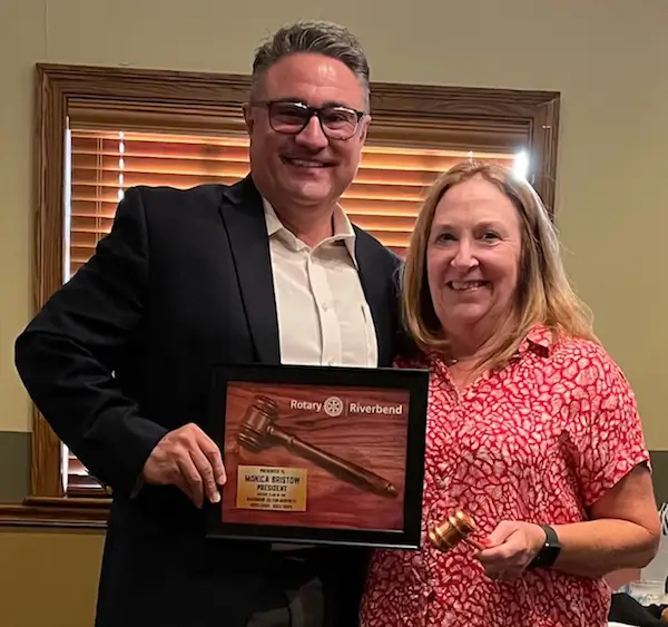 Incoming president Eric McRoy presents 2-year term past president Monica Bristow with appreciation plaque.