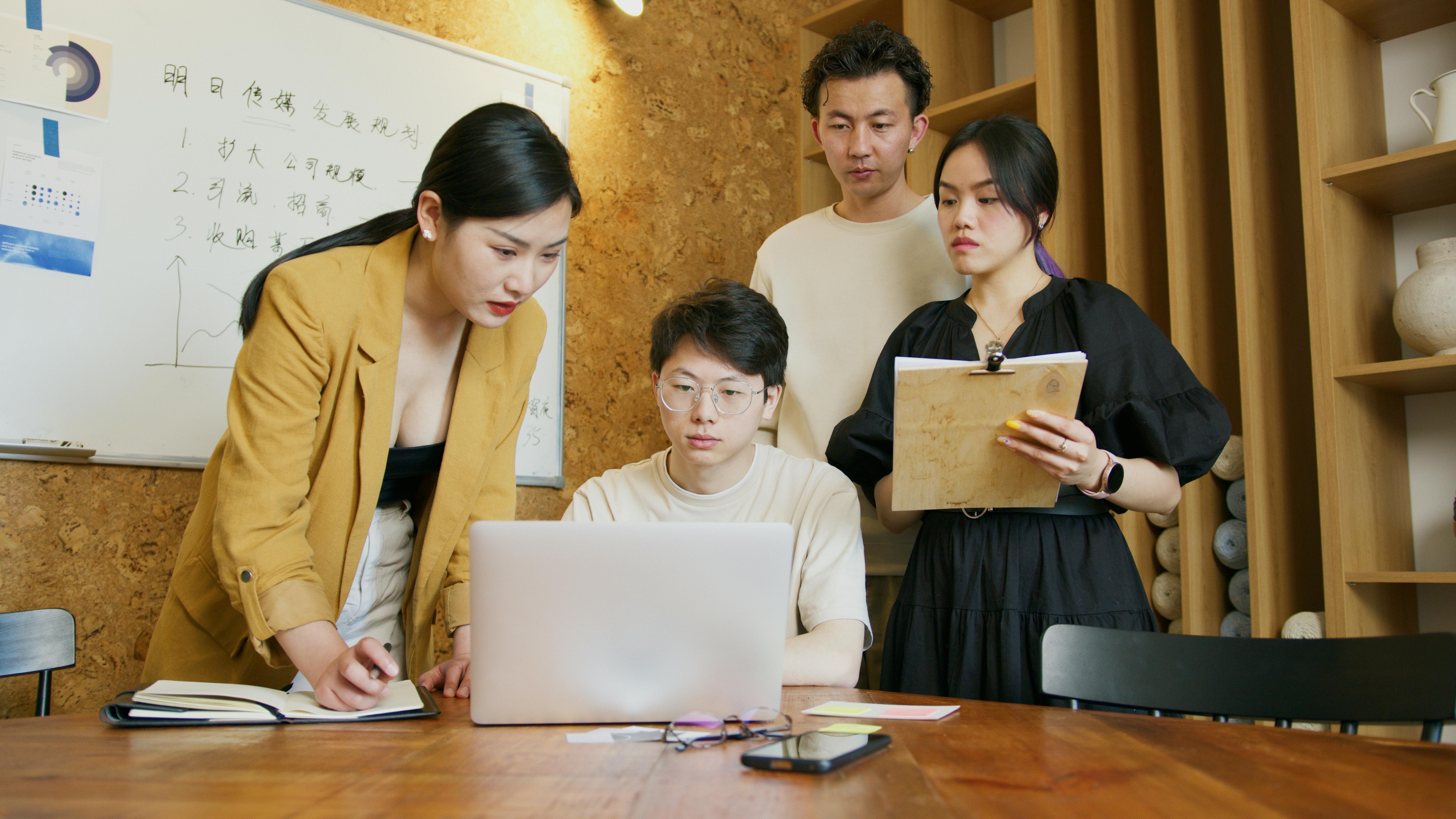 Team collaborating through a unified business communication system on laptops and mobile devices Team collaborating through a unified business communication system on laptops and mobile devices