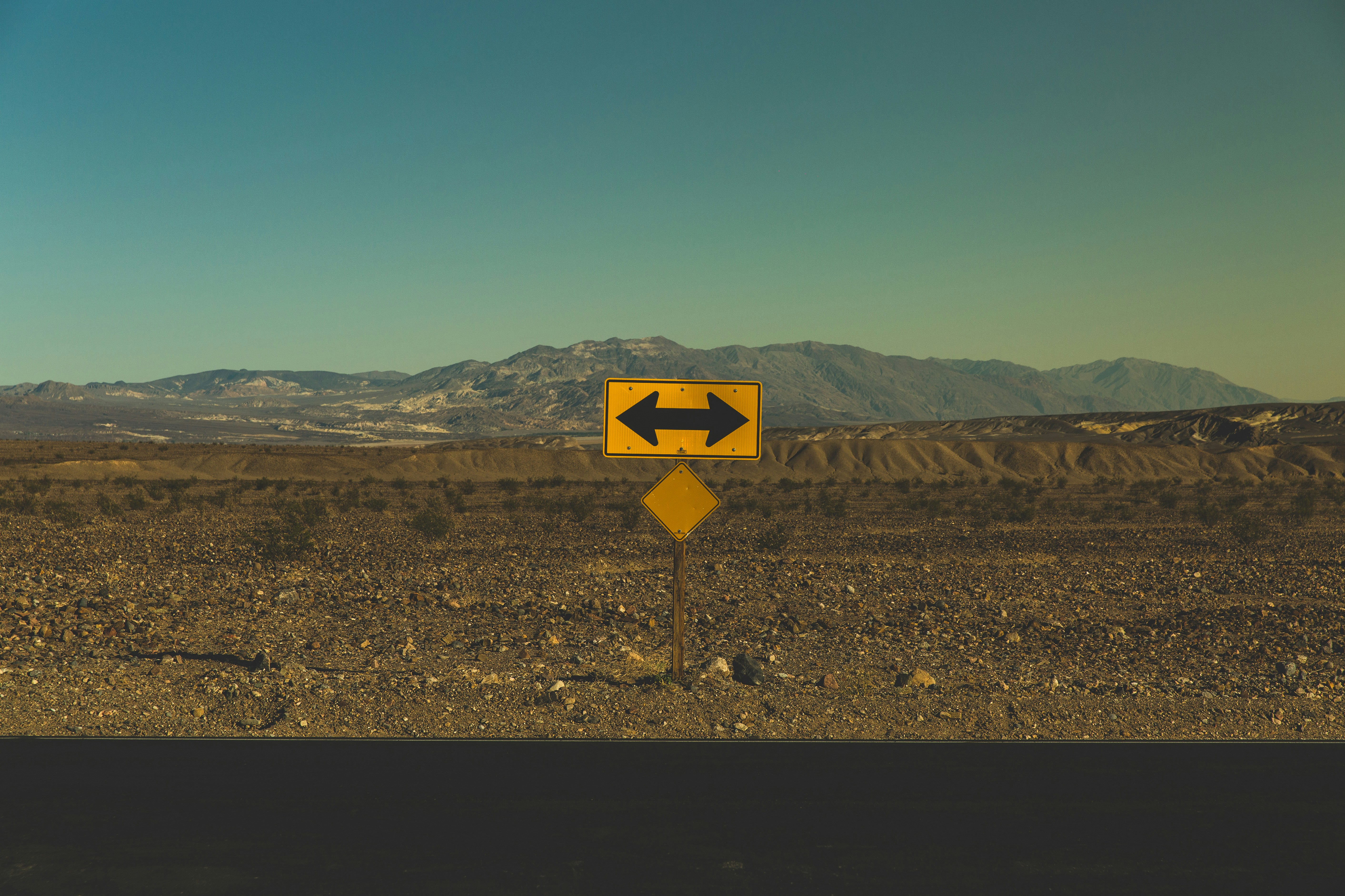 A road sign with two arrows pointing left and right A road sign with two arrows pointing left and right