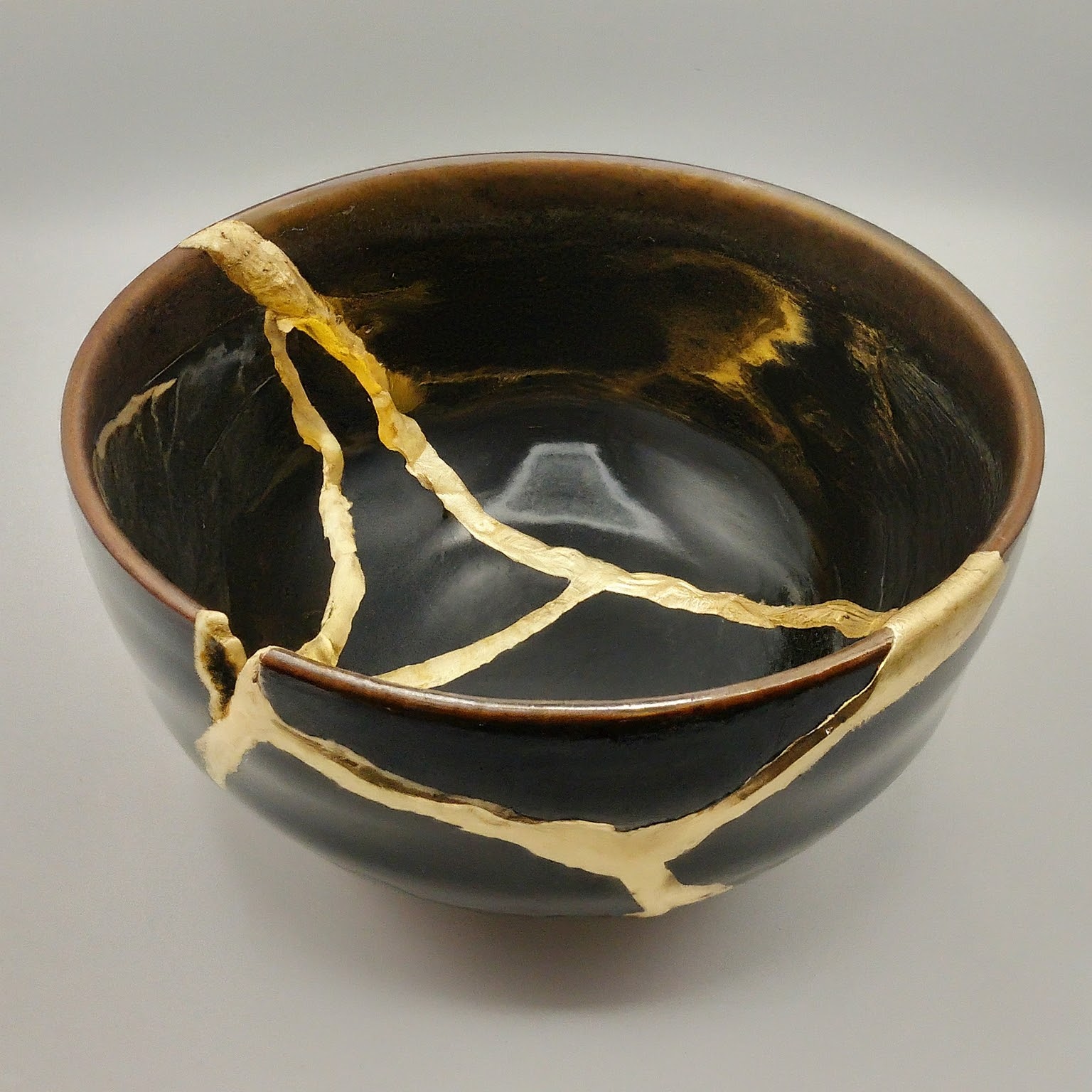a black cracked ceramic bowl a black cracked ceramic bowl