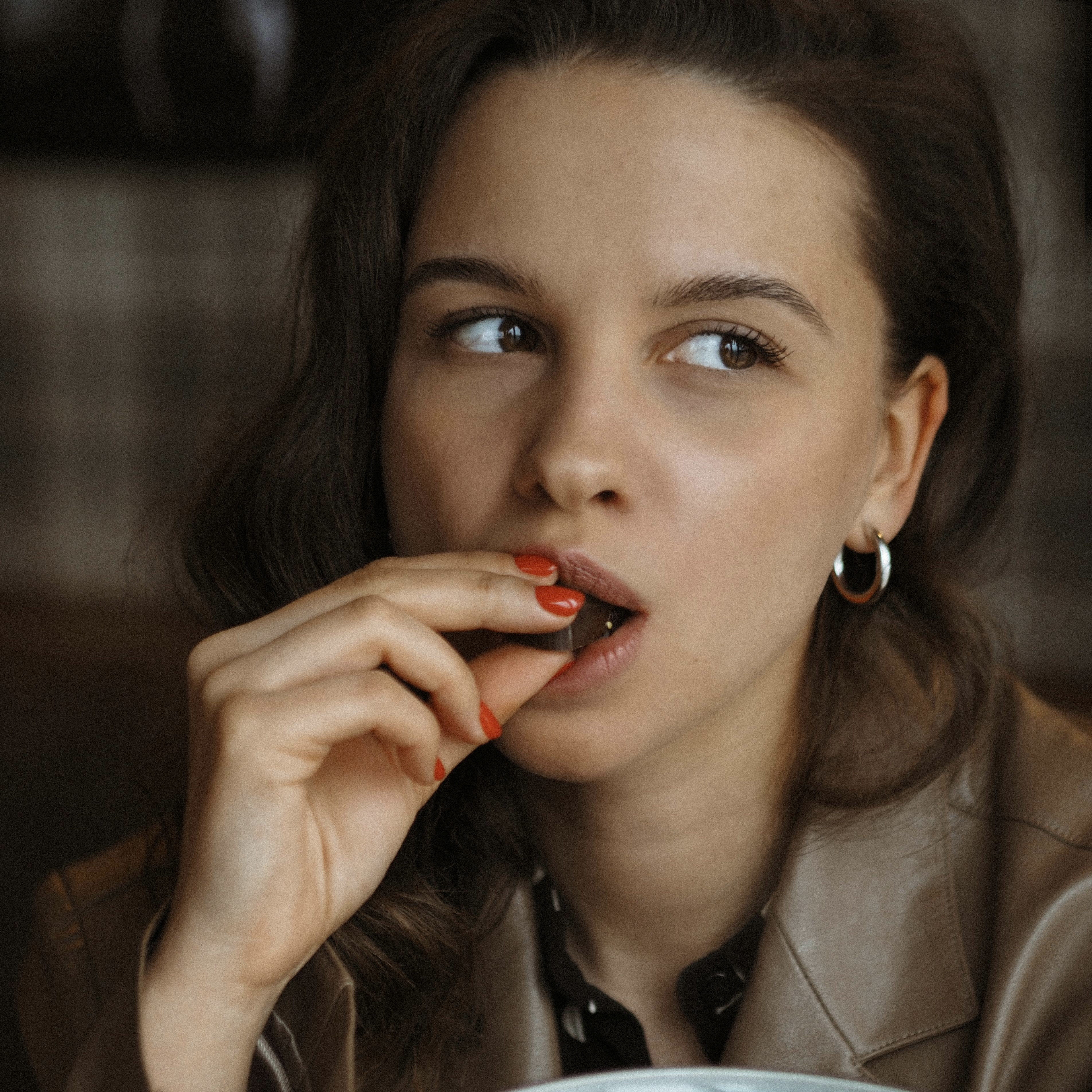 a woman eating chocolate 