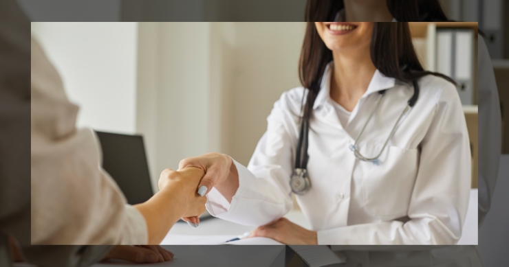 Primary care doctor handshaking her patient