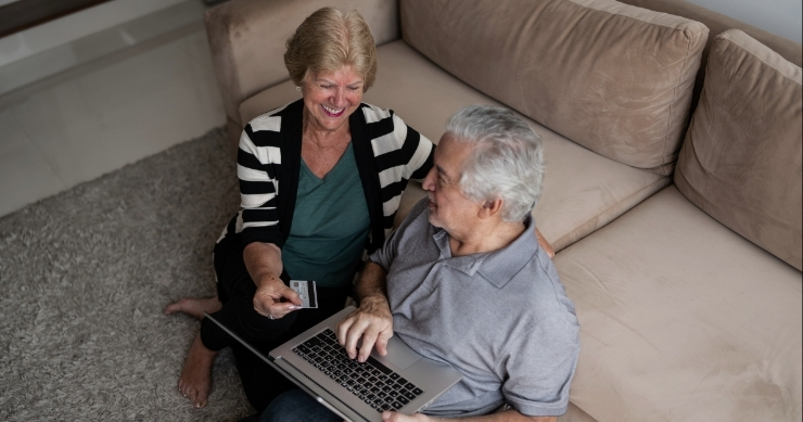 senior couple comparing healthcare plan options on a laptop