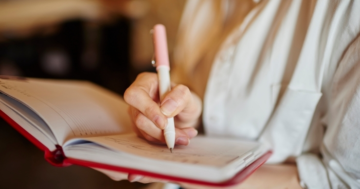 Client taking notes during Medicare consultation