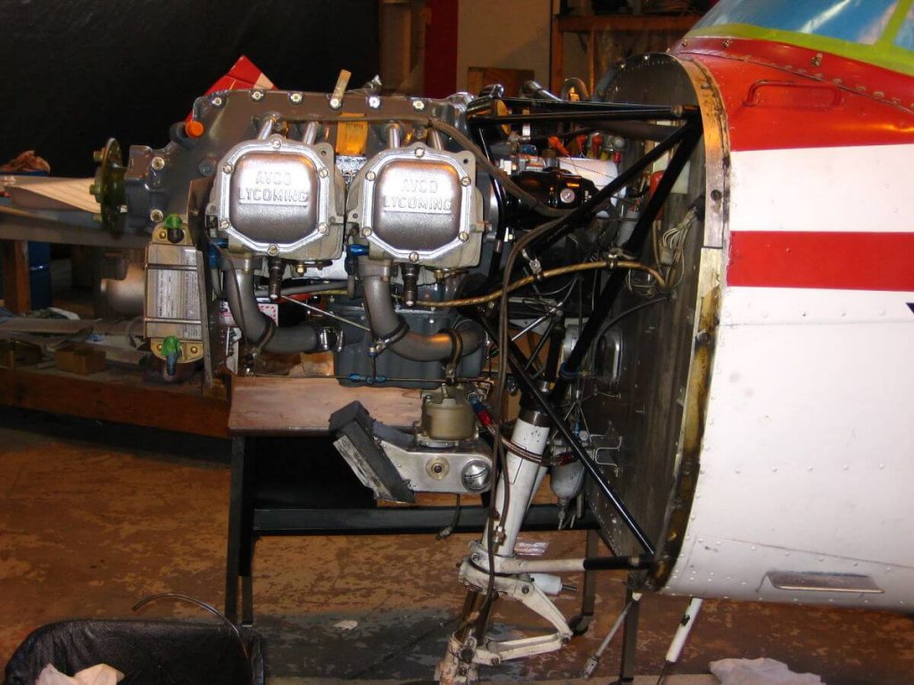 Technician performing 100-hour inspection on Piper PA28