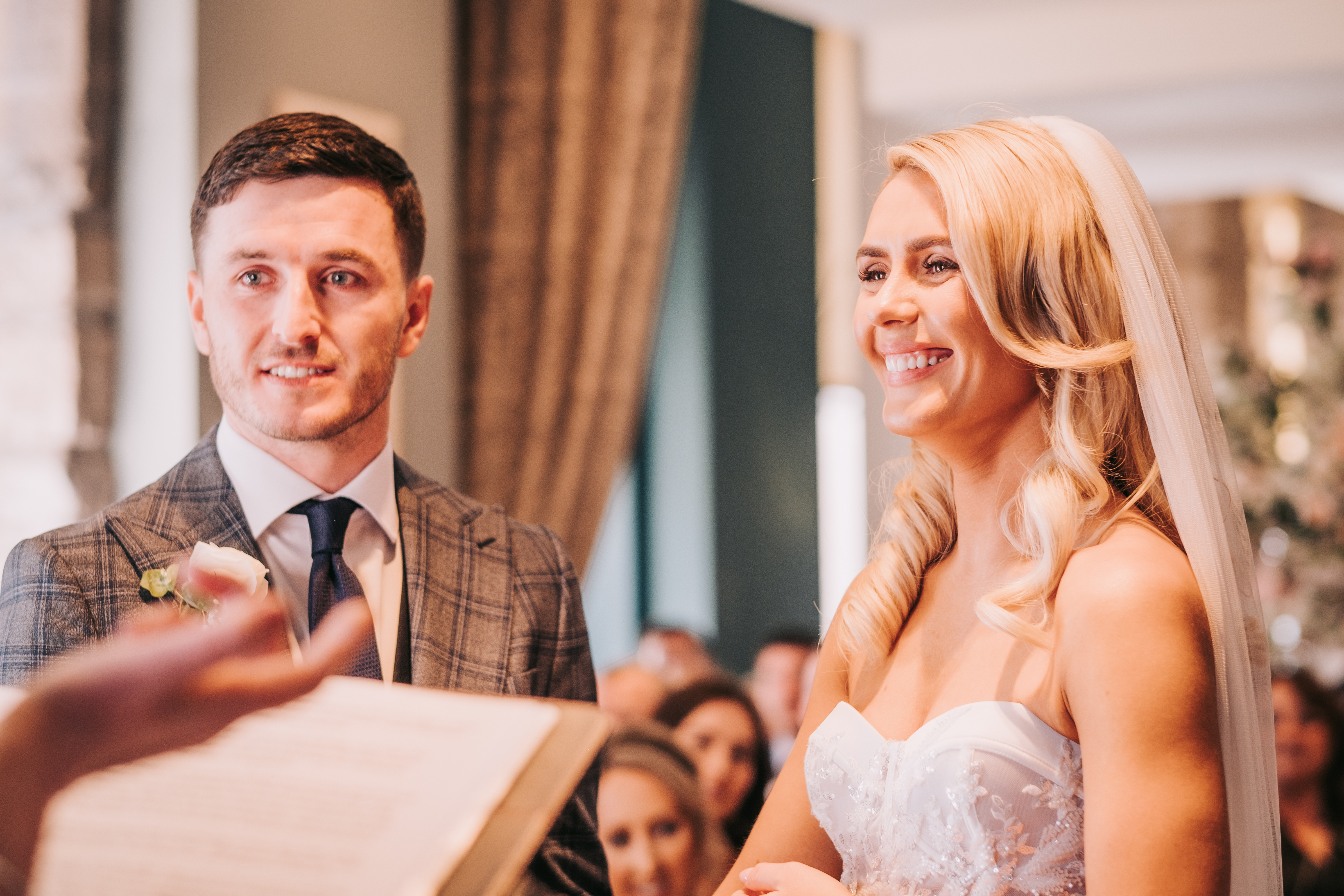 Bride and groom during wedding ceremony at Citation Glasgow, smiling as vows are read Bride and groom during wedding ceremony at Citation Glasgow, smiling as vows are read
