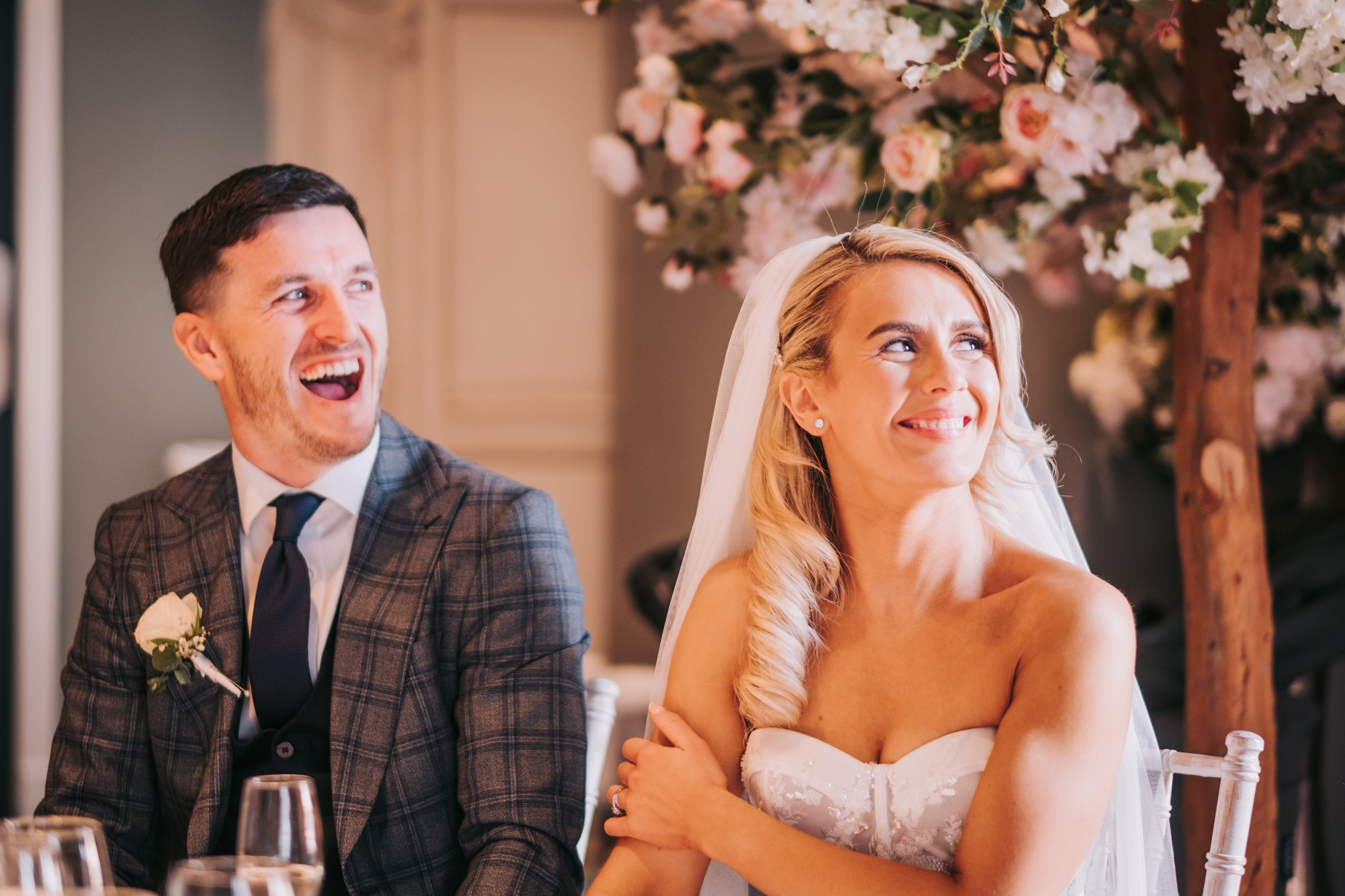 The groom laughing next to smiling bride during the reception speeches at Citation, Merchant City, Glasgow The groom laughing next to smiling bride during the reception speeches at Citation, Merchant City, Glasgow