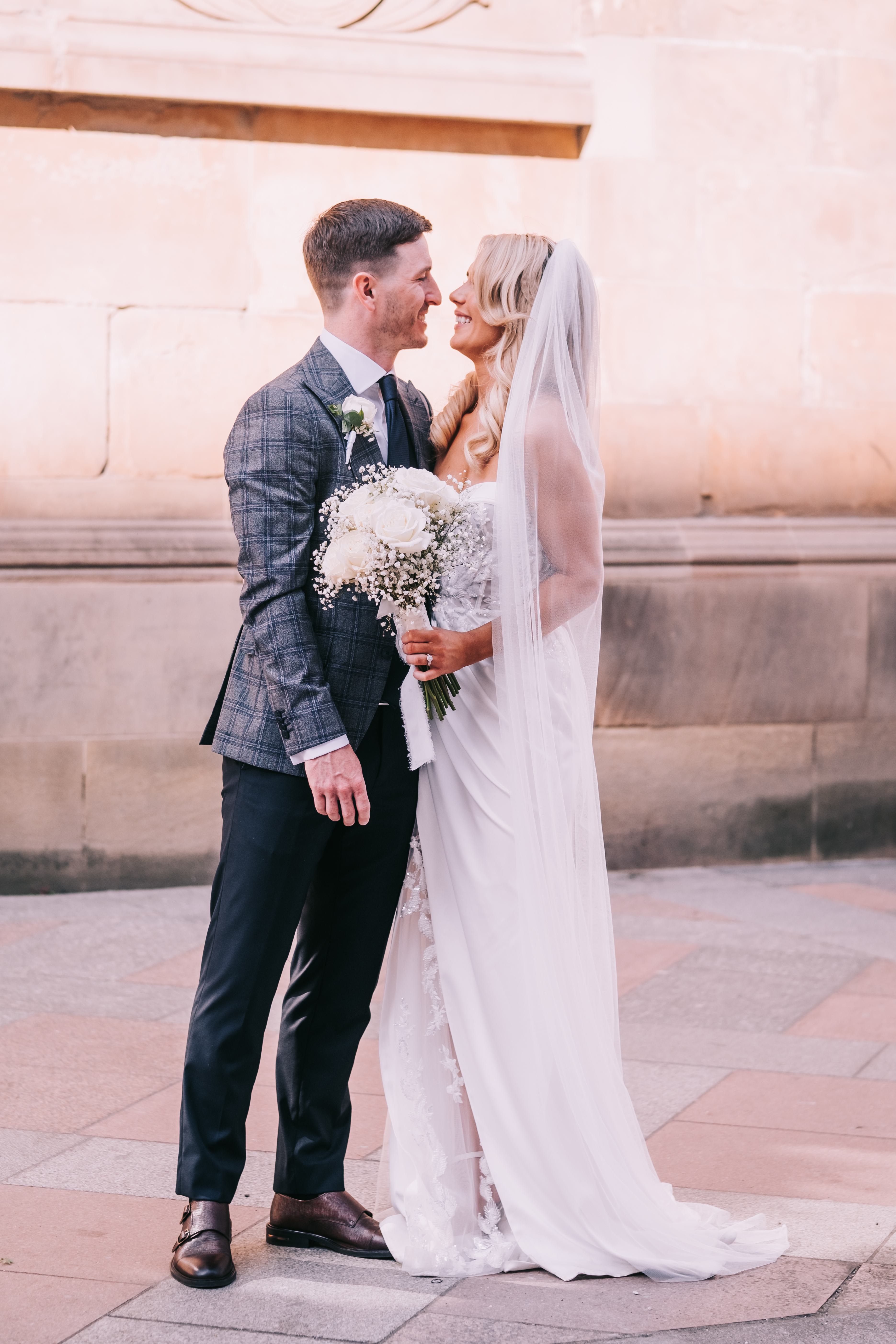 Groom and bride gazing at each other in the outside wedding venue, Citation, Glasgow, sunlight hitting the sandstone wall. Groom and bride gazing at each other in the outside wedding venue, Citation, Glasgow, sunlight hitting the sandstone wall.