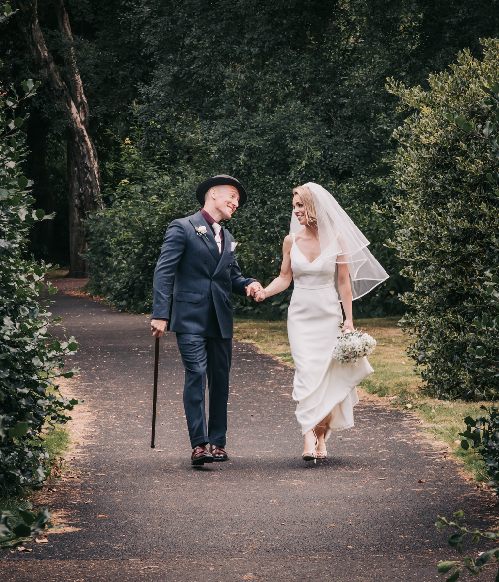 Bride and Groom holding hands and walking in Maxwell Park, Glasgow. Candid, relaxed wedding photography. Bride and Groom holding hands and walking in Maxwell Park, Glasgow. Candid, relaxed wedding photography.